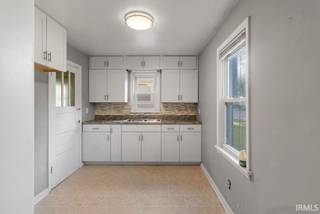 414 Klinger Ave, Plymouth, IN 46563 - kitchen featuring white cabinets, tasteful backsplash, dark countertops, and light floors