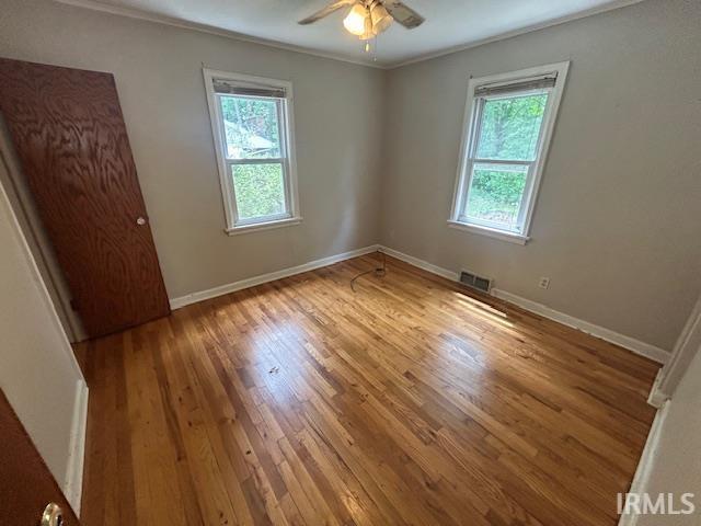 414 Klinger Ave, Plymouth, IN 46563 - unfurnished room with plenty of natural light, wood finished floors, ornamental molding, and ceiling fan