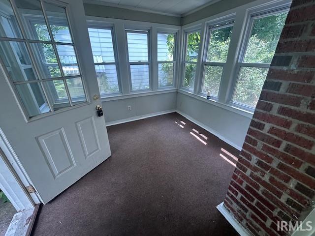 414 Klinger Ave, Plymouth, IN 46563 - unfurnished sunroom featuring carpet flooring and baseboards