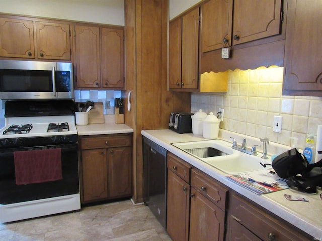 126 W W Blvd, Kokomo, IN 46902 - kitchen featuring stainless steel microwave, gas range gas stove, dishwashing machine, tasteful backsplash, and light countertops