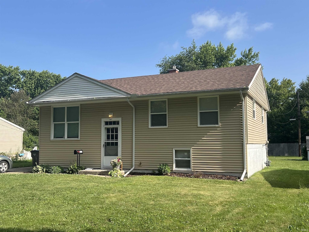 1507 W Ave, Goshen, IN 46526 - rear view of house featuring a lawn and roof with shingles