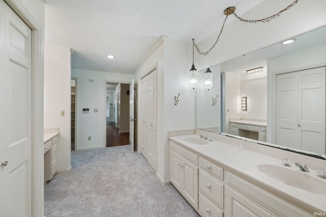 645 Pawnee Park, West Lafayette, IN 47906 - bathroom featuring double vanity, recessed lighting, a closet, ornamental molding, and carpet