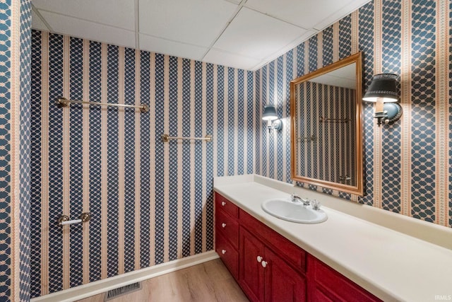 645 Pawnee Park, West Lafayette, IN 47906 - bathroom with wallpapered walls, a drop ceiling, vanity, and wood finished floors