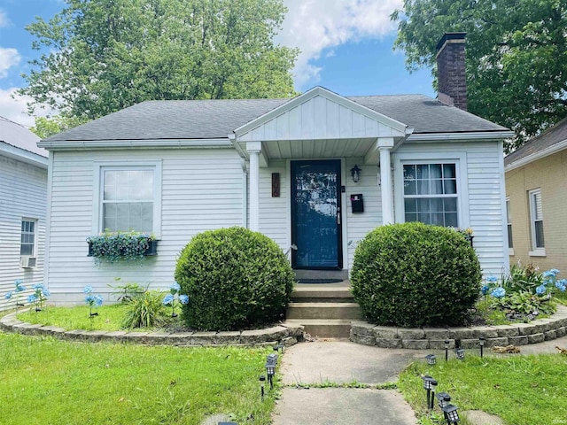 706 11th St, Tell City, IN 47586 - bungalow featuring a chimney, a shingled roof, and a front yard