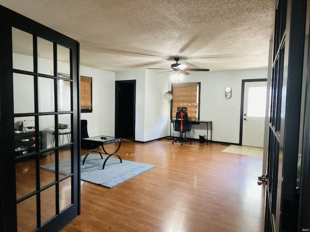 706 11th St, Tell City, IN 47586 - living area featuring ceiling fan, a textured ceiling, and wood finished floors