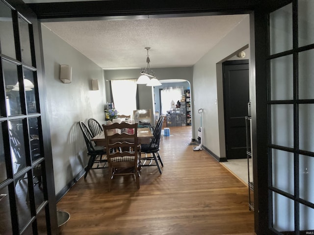 706 11th St, Tell City, IN 47586 - dining area with arched walkways, wood finished floors, and a textured ceiling