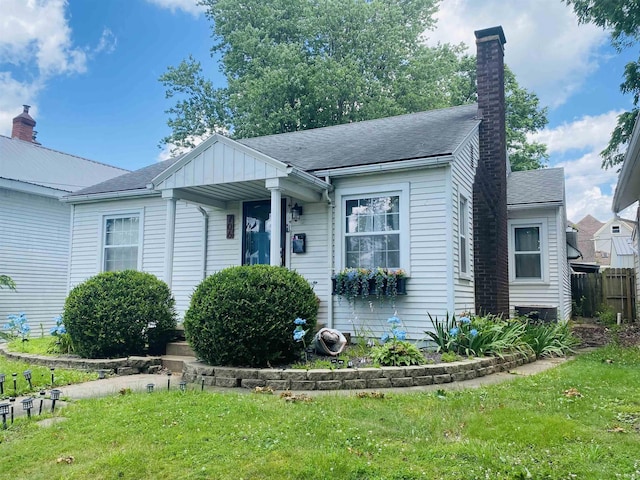 706 11th St, Tell City, IN 47586 - view of front of property with a shingled roof and a chimney