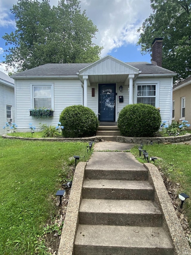706 11th St, Tell City, IN 47586 - view of front facade featuring a front yard and a chimney