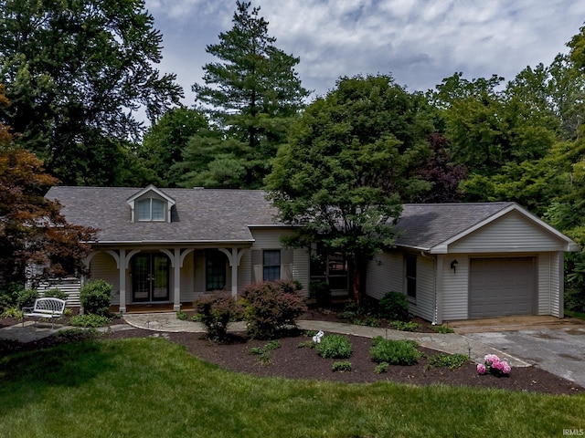 2200 E Boonville New Harmony Rd, Evansville, IN 47725 - view of front of property featuring a porch, asphalt driveway, roof with shingles, a garage, and a front yard