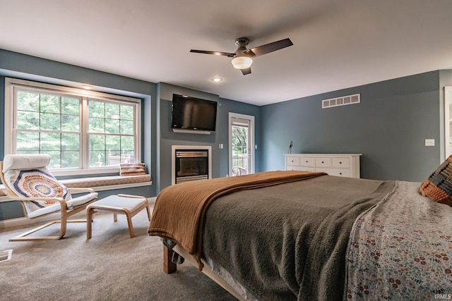 2200 E Boonville New Harmony Rd, Evansville, IN 47725 - bedroom featuring carpet floors, a glass covered fireplace, and ceiling fan
