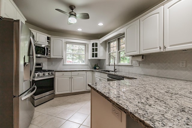 2200 E Boonville New Harmony Rd, Evansville, IN 47725 - kitchen with stainless steel appliances, a ceiling fan, light stone counters, light tile patterned floors, and tasteful backsplash