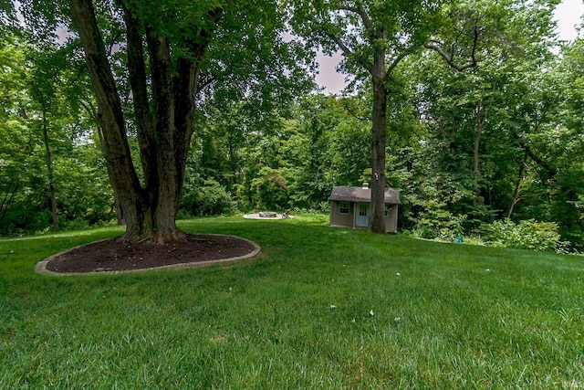 2200 E Boonville New Harmony Rd, Evansville, IN 47725 - view of grassy yard with an outdoor structure and a forest view