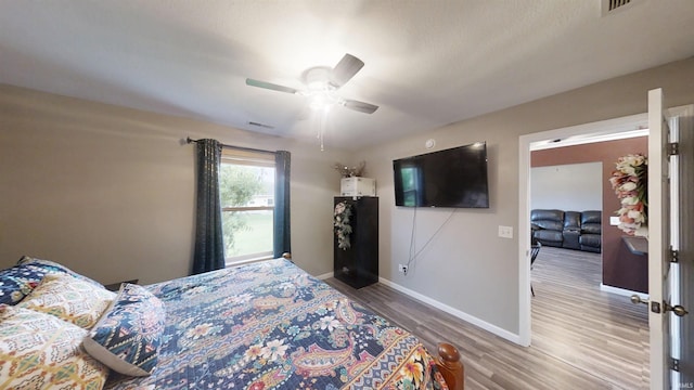 921 W Wheatfield Ln, Churubusco, IN 46723 - bedroom featuring wood finished floors and ceiling fan