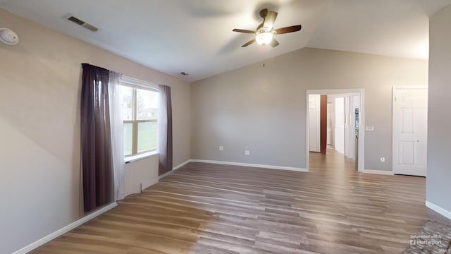 921 W Wheatfield Ln, Churubusco, IN 46723 - spare room with a ceiling fan, wood finished floors, and vaulted ceiling
