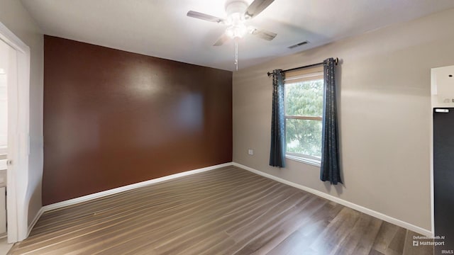 921 W Wheatfield Ln, Churubusco, IN 46723 - empty room with ceiling fan and wood finished floors