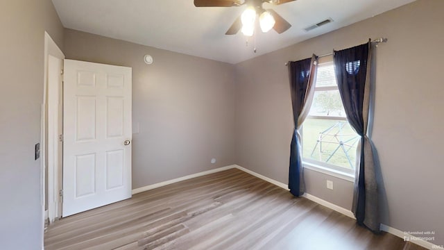921 W Wheatfield Ln, Churubusco, IN 46723 - unfurnished room featuring healthy amount of natural light, wood finished floors, and ceiling fan