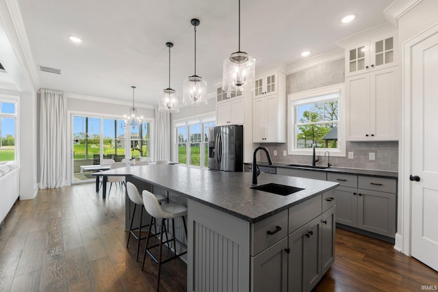 18015 Tullymore Ln, Leo, IN 46765 - kitchen featuring stainless steel refrigerator with ice dispenser, a chandelier, crown molding, dark wood-type flooring, and an island with sink
