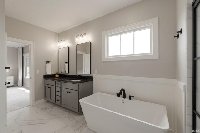 18015 Tullymore Ln, Leo, IN 46765 - full bathroom with double vanity, a freestanding bath, and marble finish flooring