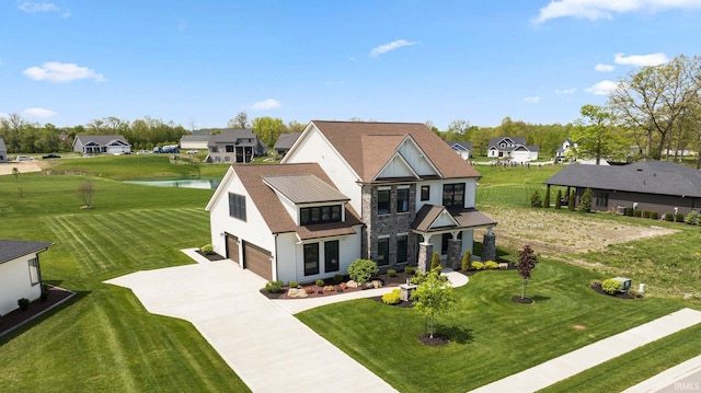18015 Tullymore Ln, Leo, IN 46765 - view of front facade featuring a garage, concrete driveway, a water view, stone siding, and a residential view