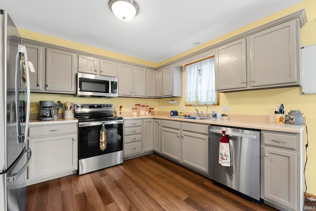 12426 Sonoma, Fort Wayne, IN 46818 - kitchen with appliances with stainless steel finishes, gray cabinetry, dark wood finished floors, and light countertops