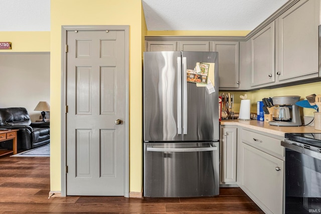 12426 Sonoma, Fort Wayne, IN 46818 - kitchen with freestanding refrigerator, stove, dark wood finished floors, light countertops, and a textured ceiling