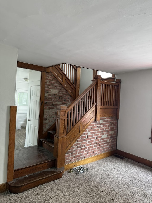 310 W Leith St, Fort Wayne, IN 46807 - stairs with carpet and brick wall