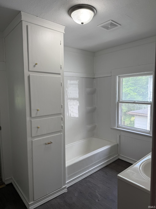 310 W Leith St, Fort Wayne, IN 46807 - full bath featuring wood finished floors, vanity, bathtub / shower combination, and a textured ceiling