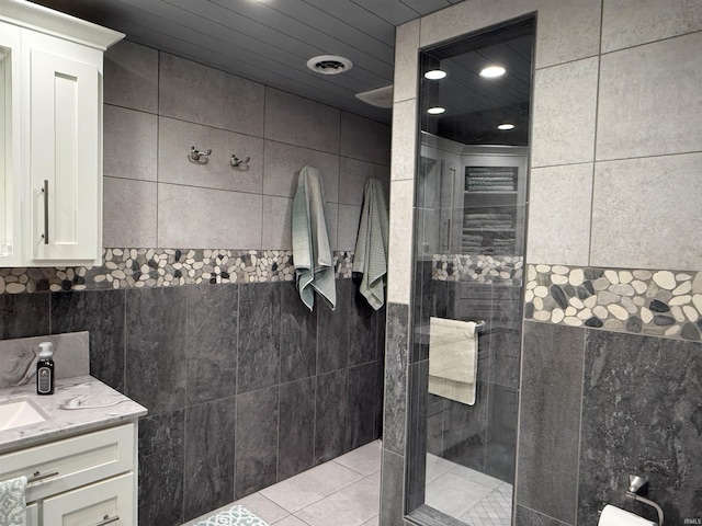 299 Spring Haven Rd, Mitchell, IN 47446 - bathroom with tile walls, walk in shower, vanity, and tile patterned flooring
