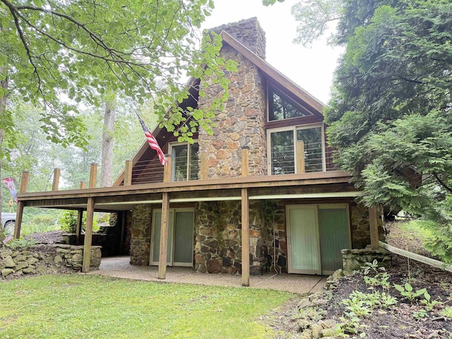 299 Spring Haven Rd, Mitchell, IN 47446 - back of house featuring stone siding, a lawn, and a deck