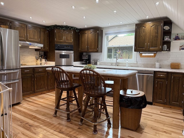 299 Spring Haven Rd, Mitchell, IN 47446 - kitchen with stainless steel appliances, under cabinet range hood, light countertops, light wood finished floors, and wooden ceiling