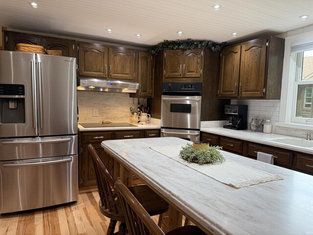 299 Spring Haven Rd, Mitchell, IN 47446 - kitchen featuring appliances with stainless steel finishes, under cabinet range hood, light countertops, light wood-type flooring, and recessed lighting