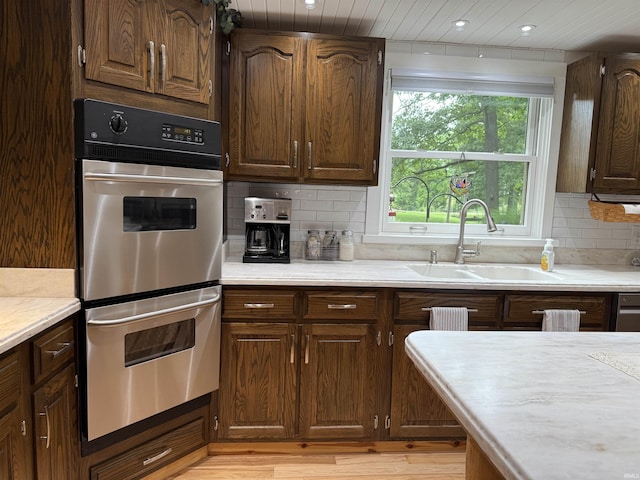 299 Spring Haven Rd, Mitchell, IN 47446 - kitchen with stainless steel double oven, light countertops, decorative backsplash, light wood-style flooring, and recessed lighting