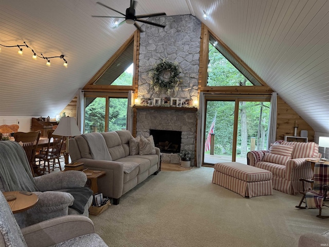 299 Spring Haven Rd, Mitchell, IN 47446 - living area with a ceiling fan, healthy amount of natural light, a stone fireplace, carpet flooring, and high vaulted ceiling
