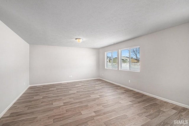 1417 Din Cv, Huntertown, IN 46748 - unfurnished room featuring wood finished floors and a textured ceiling