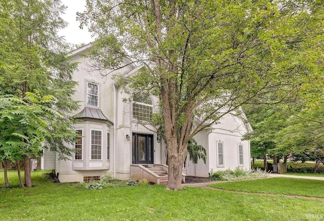 1045 E Chris Ln, Bloomington, IN 47401 - view of front of house with stucco siding and a front lawn