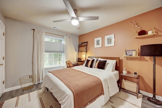 1045 E Chris Ln, Bloomington, IN 47401 - bedroom featuring wood finished floors, a textured ceiling, and ceiling fan
