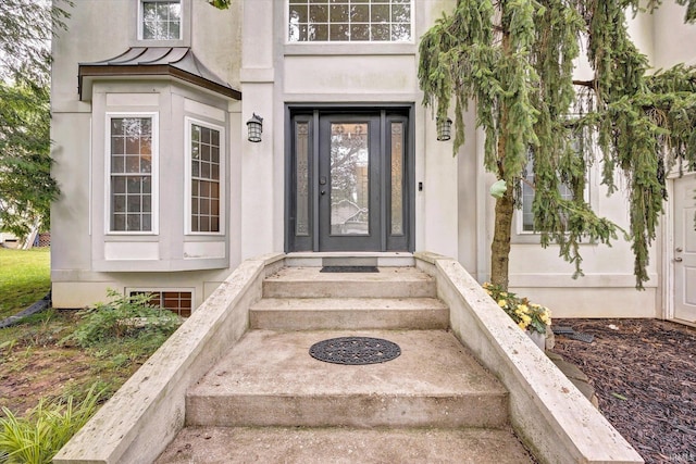 1045 E Chris Ln, Bloomington, IN 47401 - view of exterior entry with stucco siding and a standing seam roof