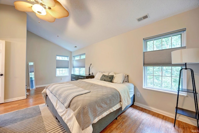 1045 E Chris Ln, Bloomington, IN 47401 - bedroom featuring multiple windows, wood finished floors, vaulted ceiling, and ceiling fan