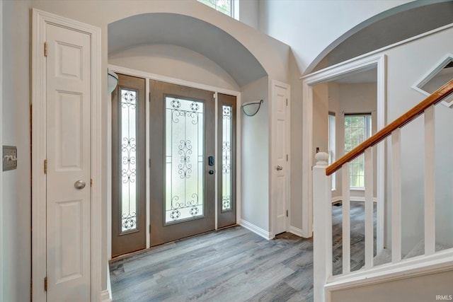 1045 E Chris Ln, Bloomington, IN 47401 - entrance foyer featuring wood finished floors, stairway, and arched walkways