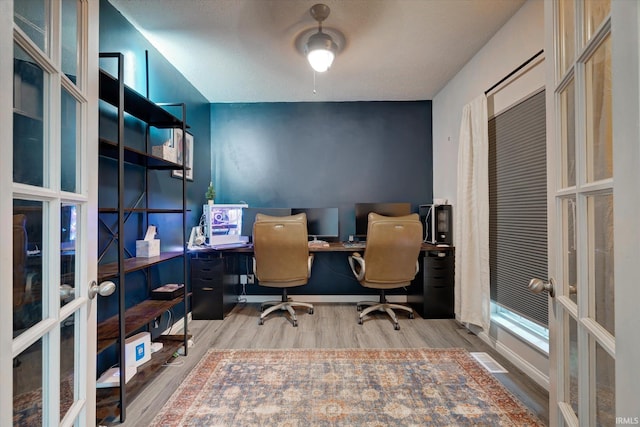 1045 E Chris Ln, Bloomington, IN 47401 - home office with french doors, wood finished floors, and a textured ceiling