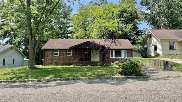 54213 Terrace Ln, South Bend, IN 46635 - view of front of house featuring brick siding, asphalt driveway, and a front lawn