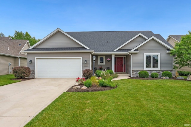 10057 Chapmans Cv, Fort Wayne, IN 46835 - view of front facade featuring an attached garage, stone siding, a front lawn, and concrete driveway