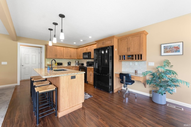 10057 Chapmans Cv, Fort Wayne, IN 46835 - kitchen with black appliances, tasteful backsplash, dark wood-type flooring, a breakfast bar area, and recessed lighting