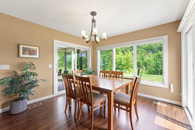 10057 Chapmans Cv, Fort Wayne, IN 46835 - dining area with a chandelier, plenty of natural light, and dark wood finished floors