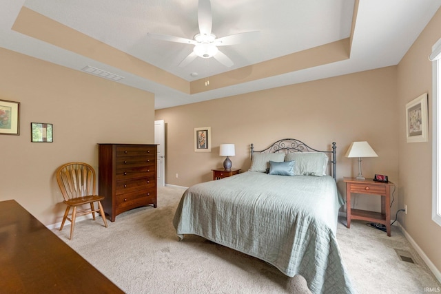 10057 Chapmans Cv, Fort Wayne, IN 46835 - bedroom featuring light colored carpet, a tray ceiling, and a ceiling fan