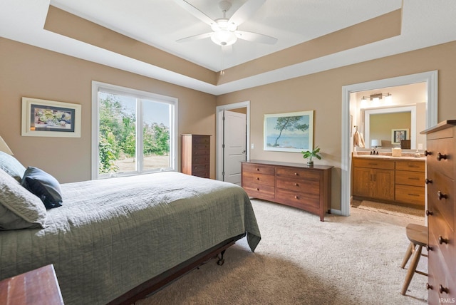 10057 Chapmans Cv, Fort Wayne, IN 46835 - bedroom with light colored carpet, a raised ceiling, connected bathroom, and a ceiling fan