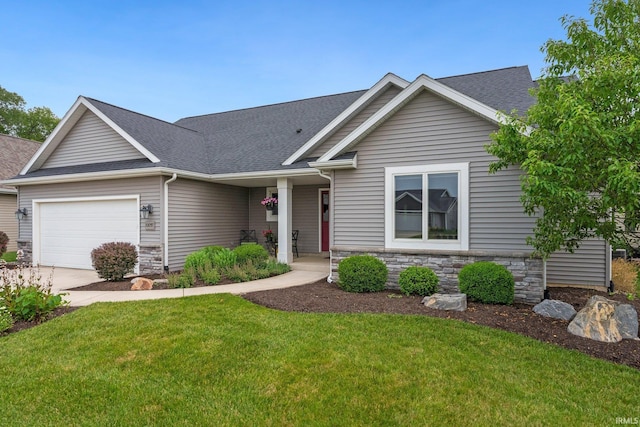 10057 Chapmans Cv, Fort Wayne, IN 46835 - view of front facade with a garage, a front lawn, stone siding, and a shingled roof