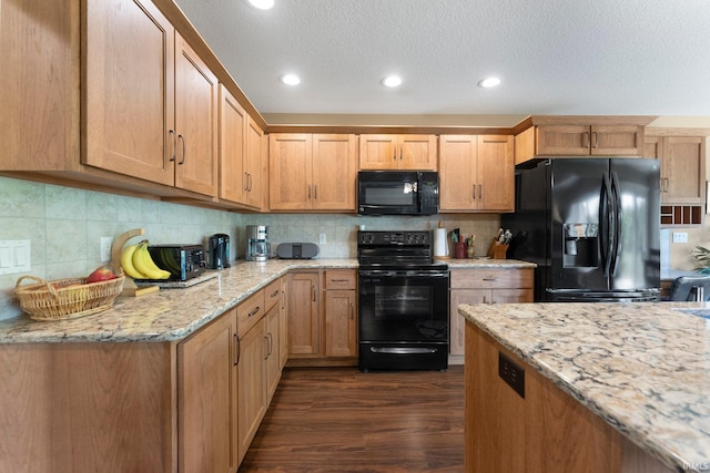 10057 Chapmans Cv, Fort Wayne, IN 46835 - kitchen featuring black appliances, dark wood-type flooring, recessed lighting, backsplash, and light stone counters