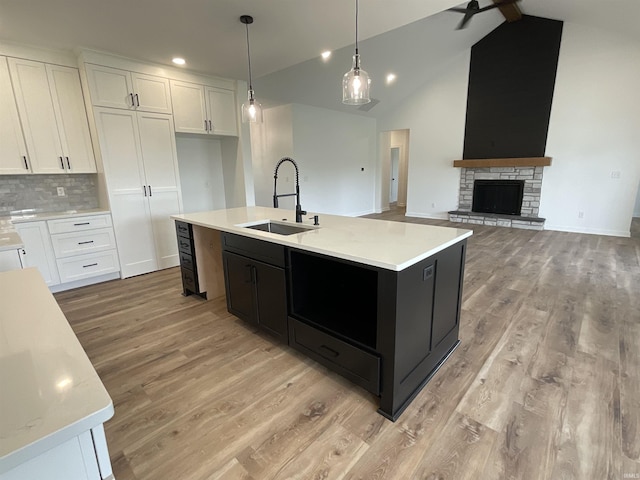 1609 Diane Dr, Ossian, IN 46777 - kitchen with white cabinetry, light countertops, light wood-type flooring, dark cabinetry, and recessed lighting