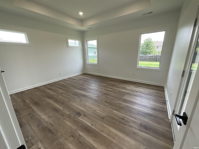 1609 Diane Dr, Ossian, IN 46777 - unfurnished room with a raised ceiling, healthy amount of natural light, dark wood-style floors, and recessed lighting